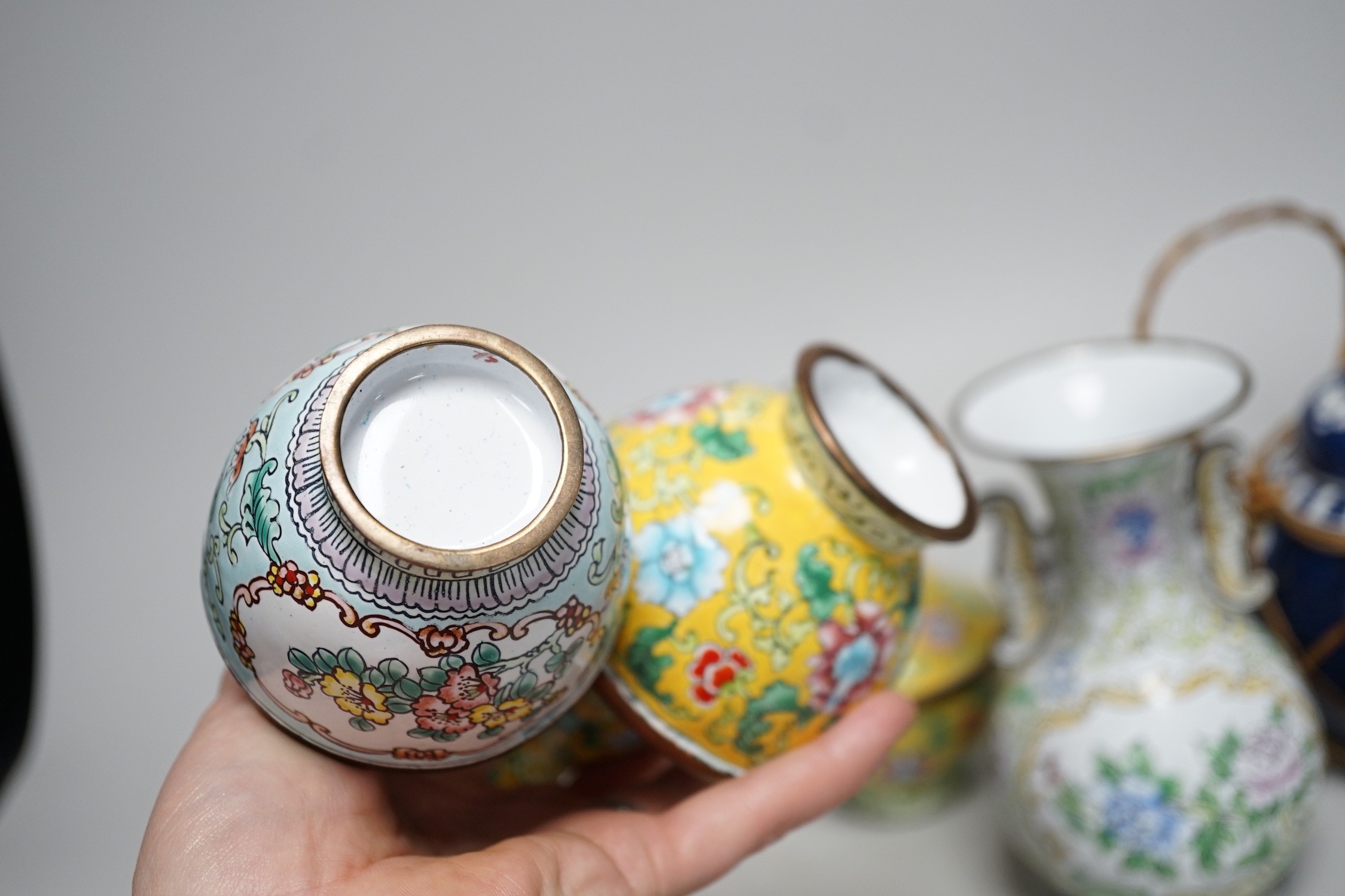 A group of Canton enamel vases, a pair of cloisonné enamel jars and a blue and white jar. Tallest 15.5cm